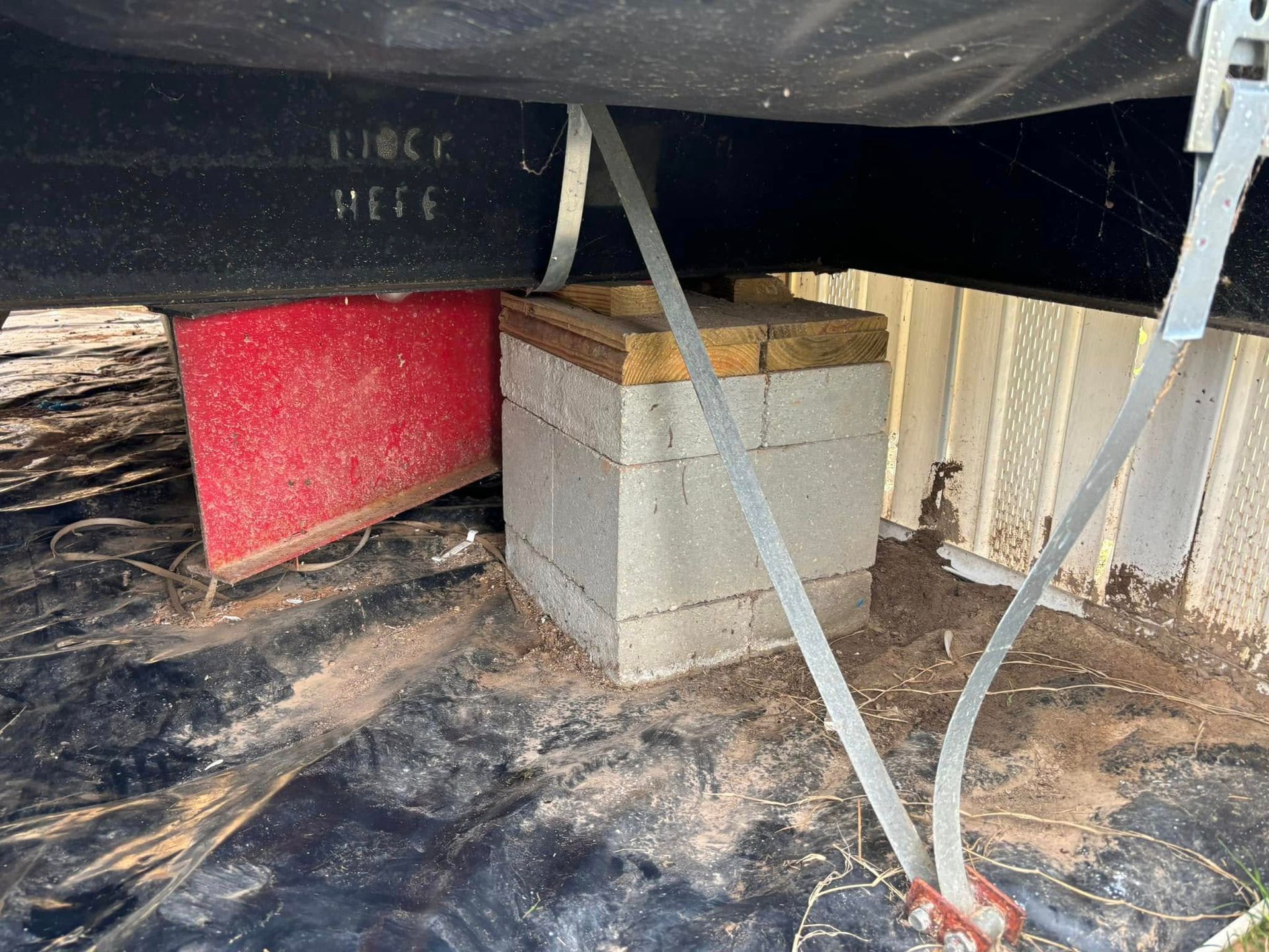 A concrete block is sitting under a black tarp.