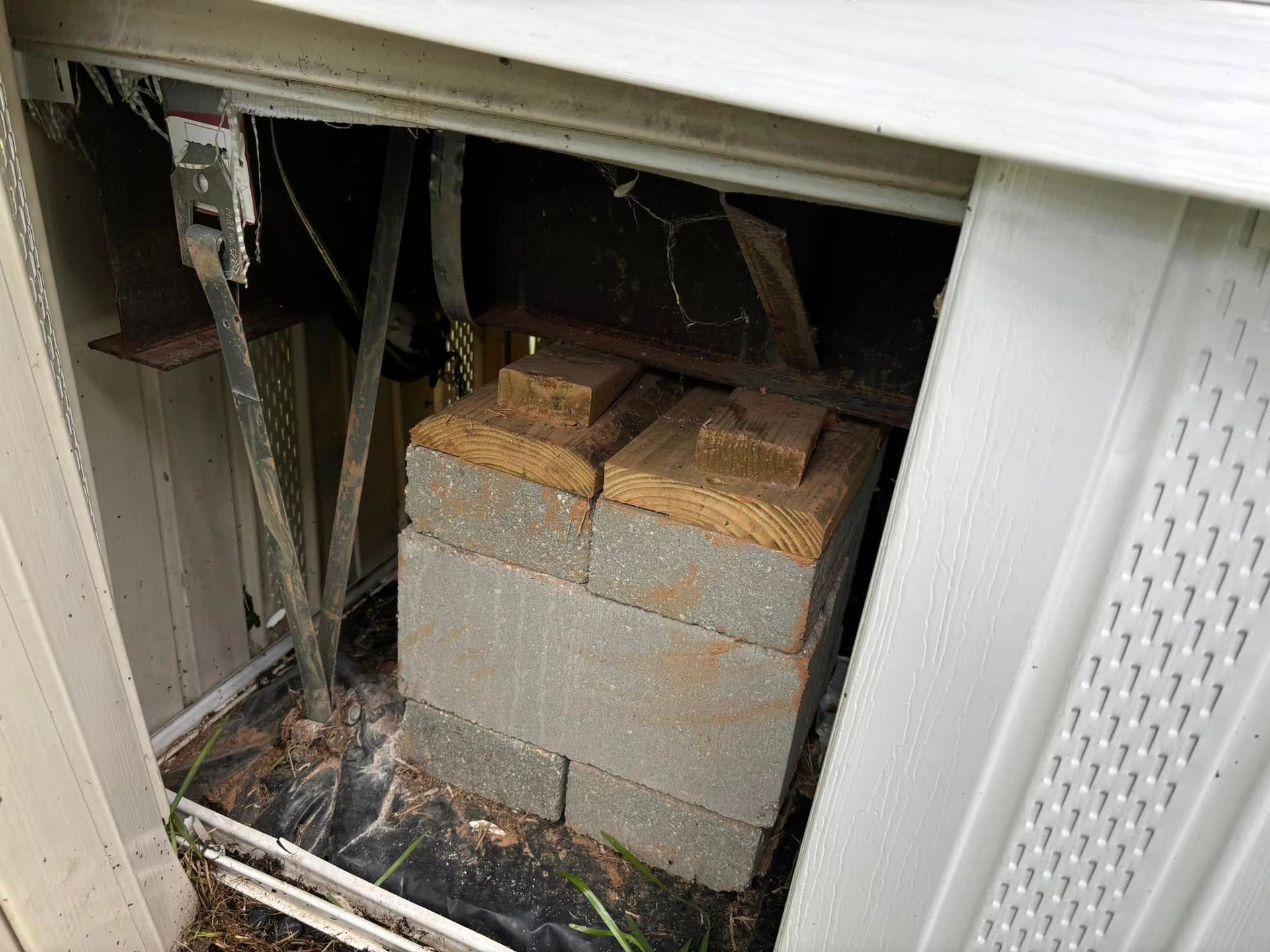 A stack of bricks is sitting inside of a garage door.