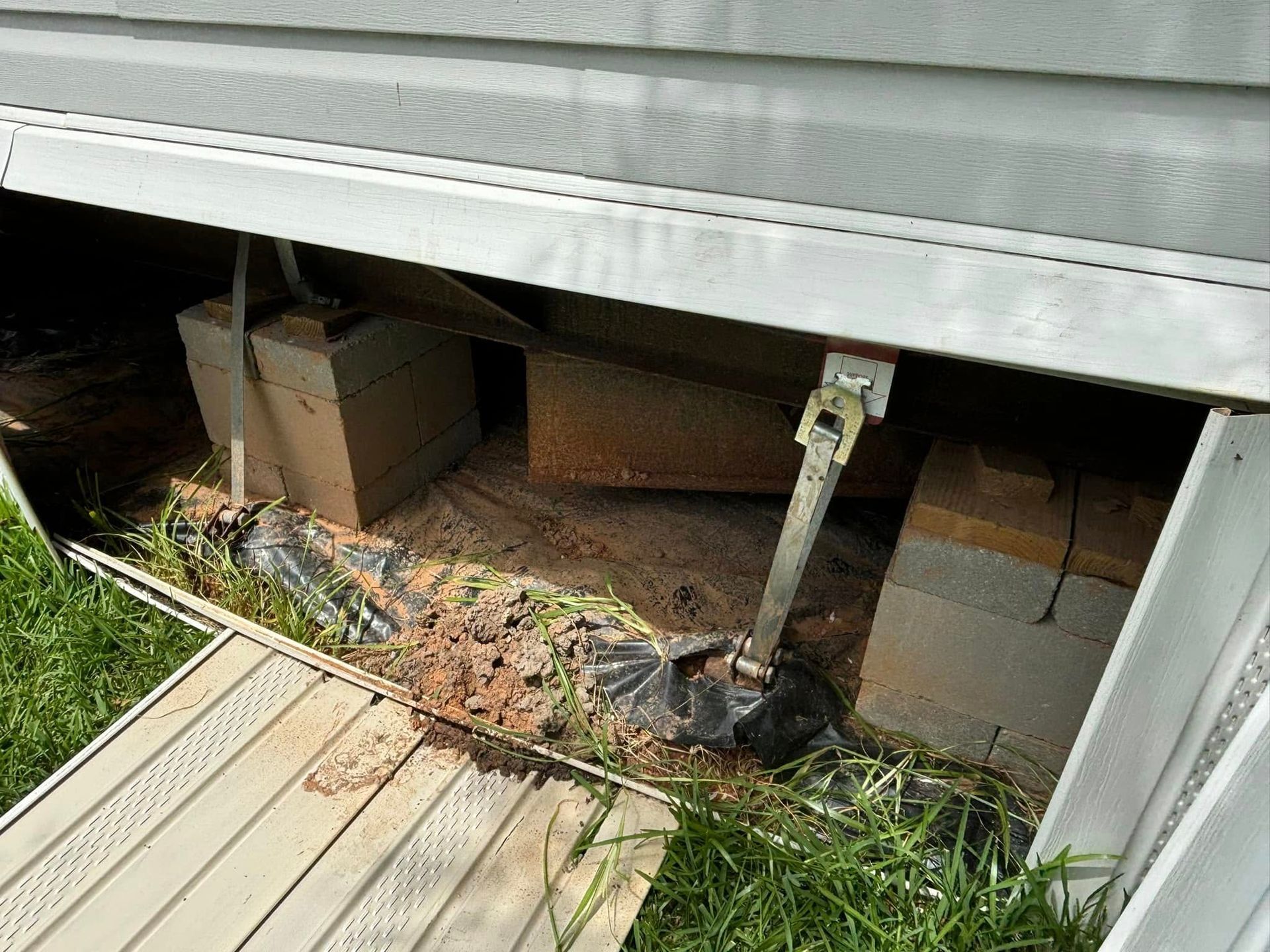 A house with a lot of boxes underneath it.