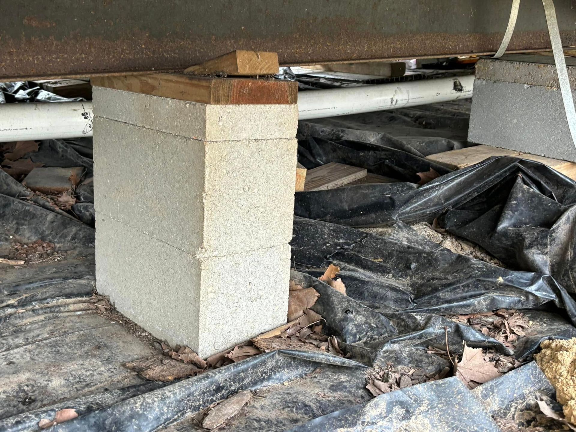 A concrete block is sitting on top of a wooden block.