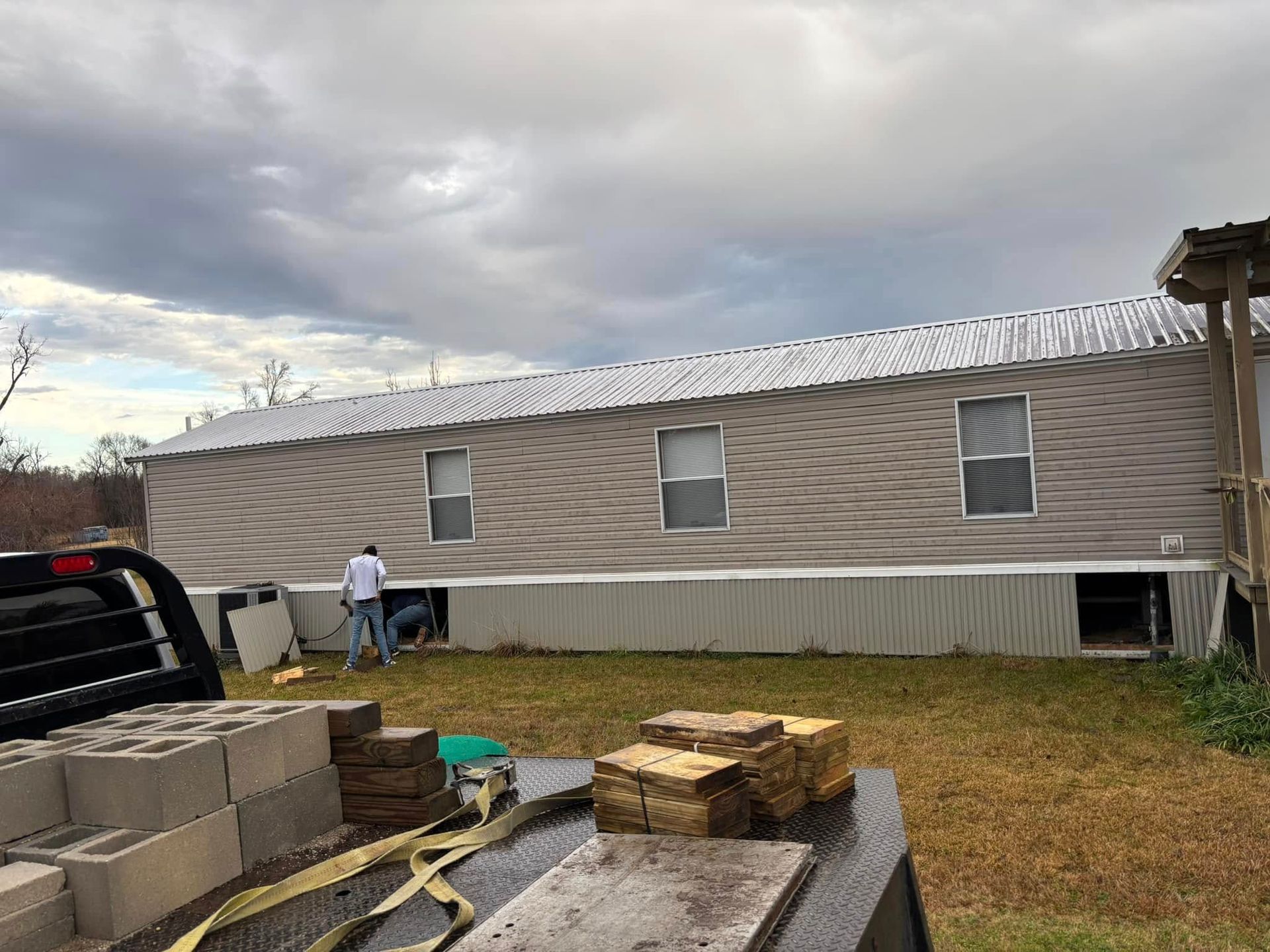 A man is standing in front of a mobile home.