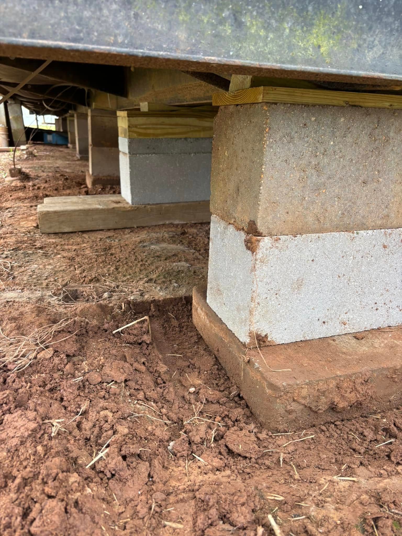 A concrete block is sitting on top of a pile of dirt.