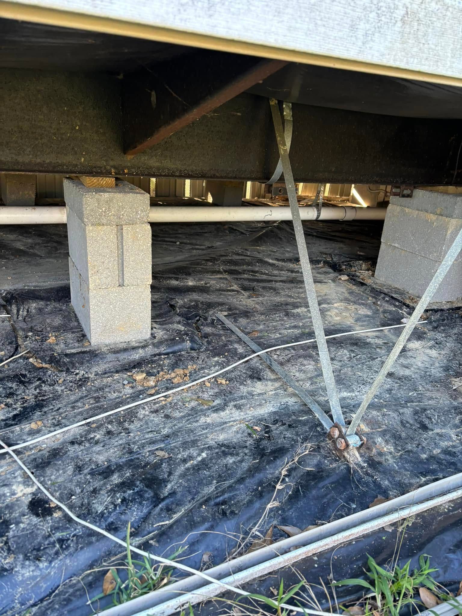 A close up of a concrete pillar under a building.