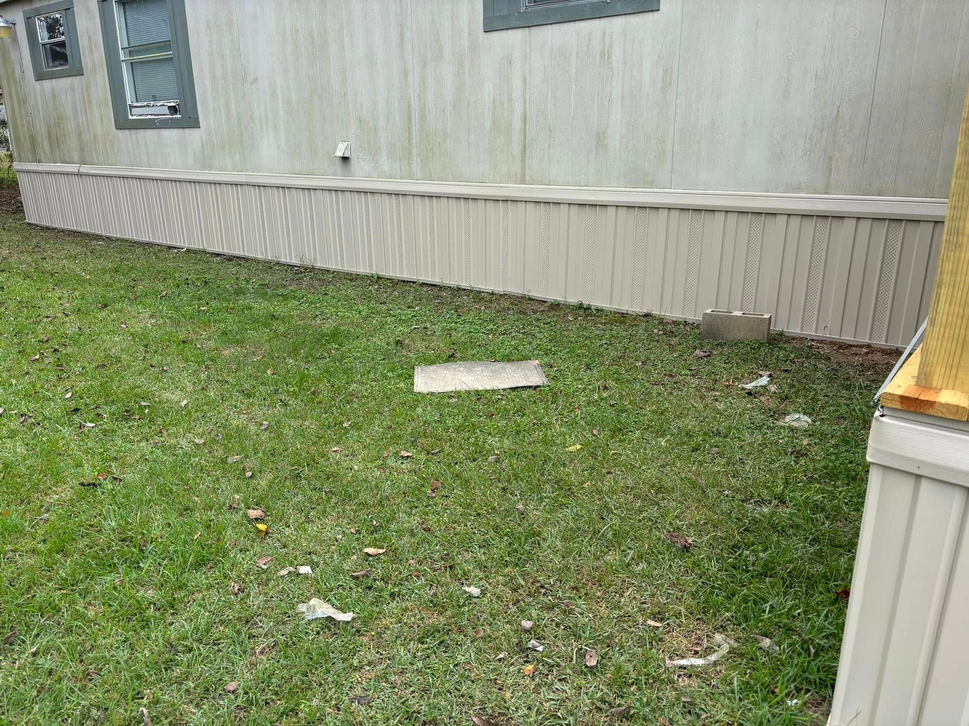 A mobile home is sitting on top of a lush green lawn.