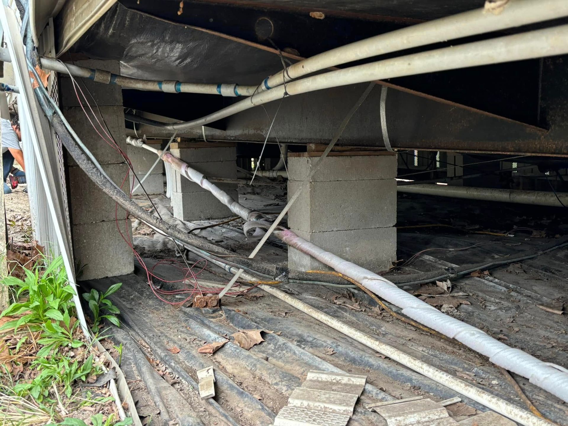 A bunch of wires are hanging from the ceiling of a building.