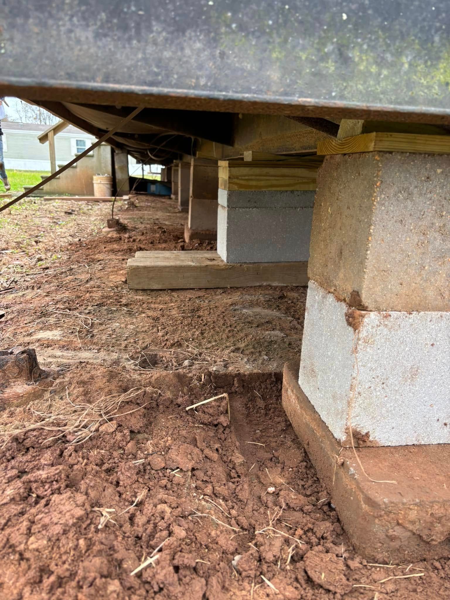 A house is sitting on top of a pile of dirt.