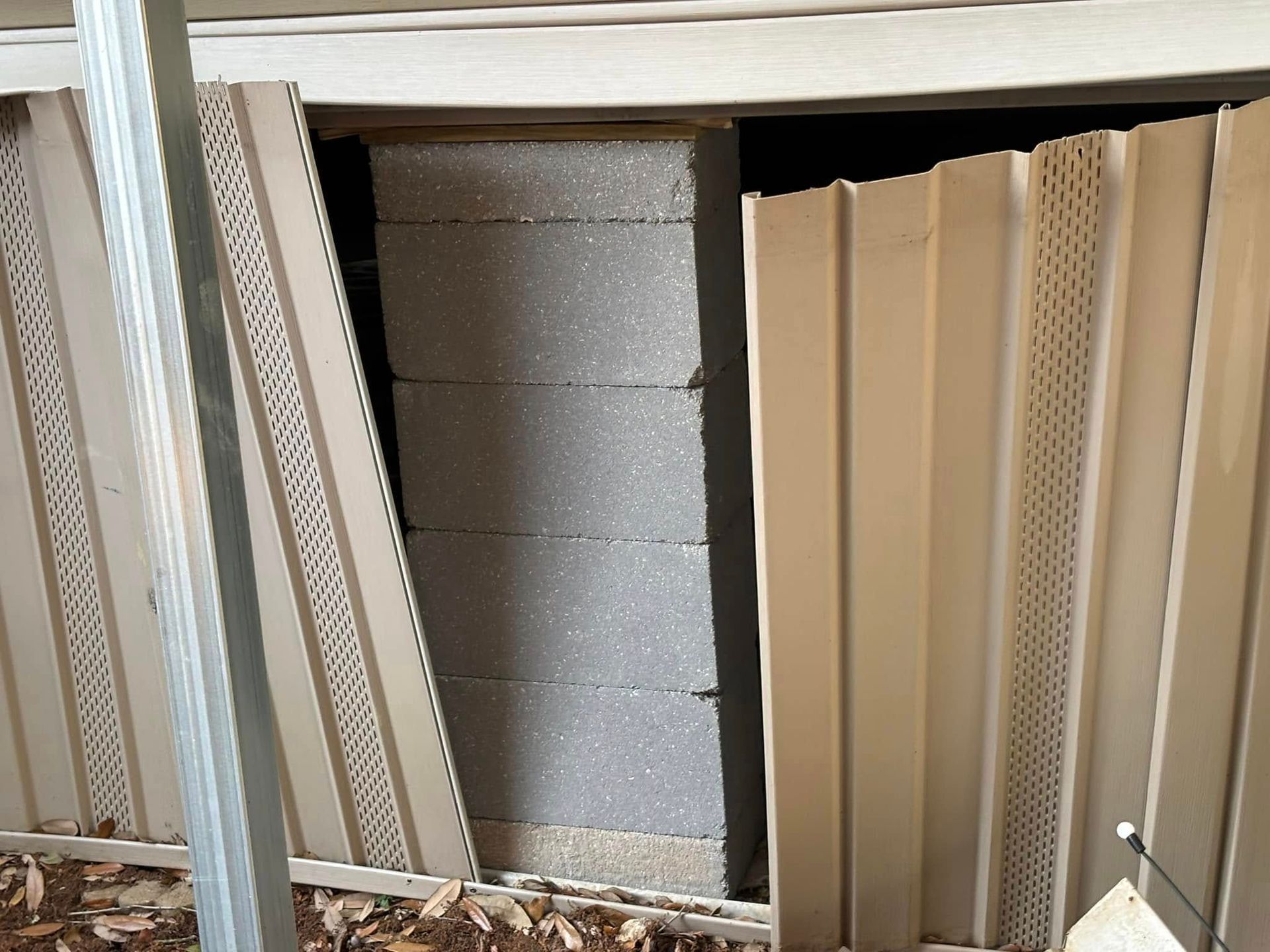 A wall with a hole in it that looks like a door