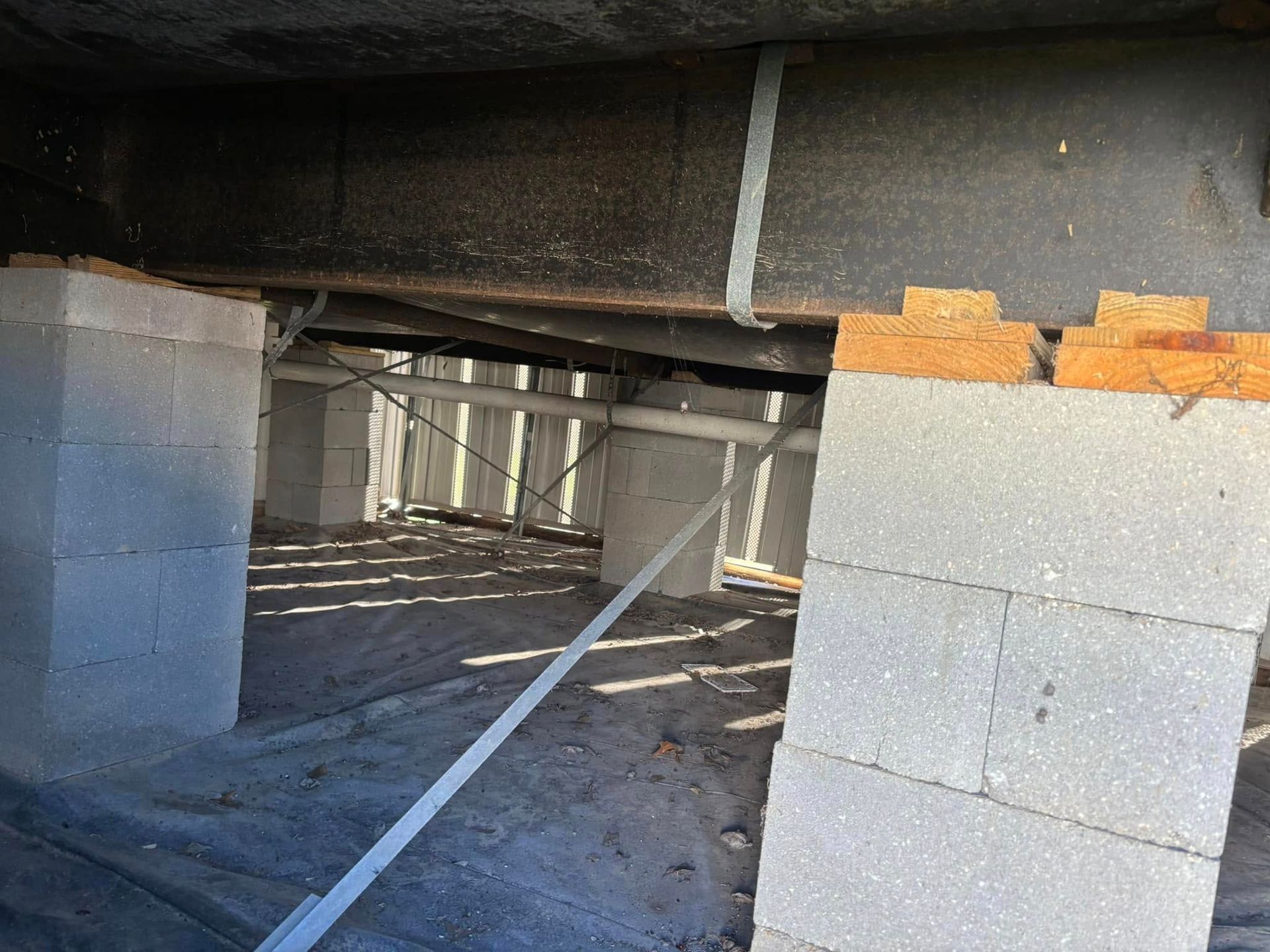 A building under construction with concrete blocks and pipes