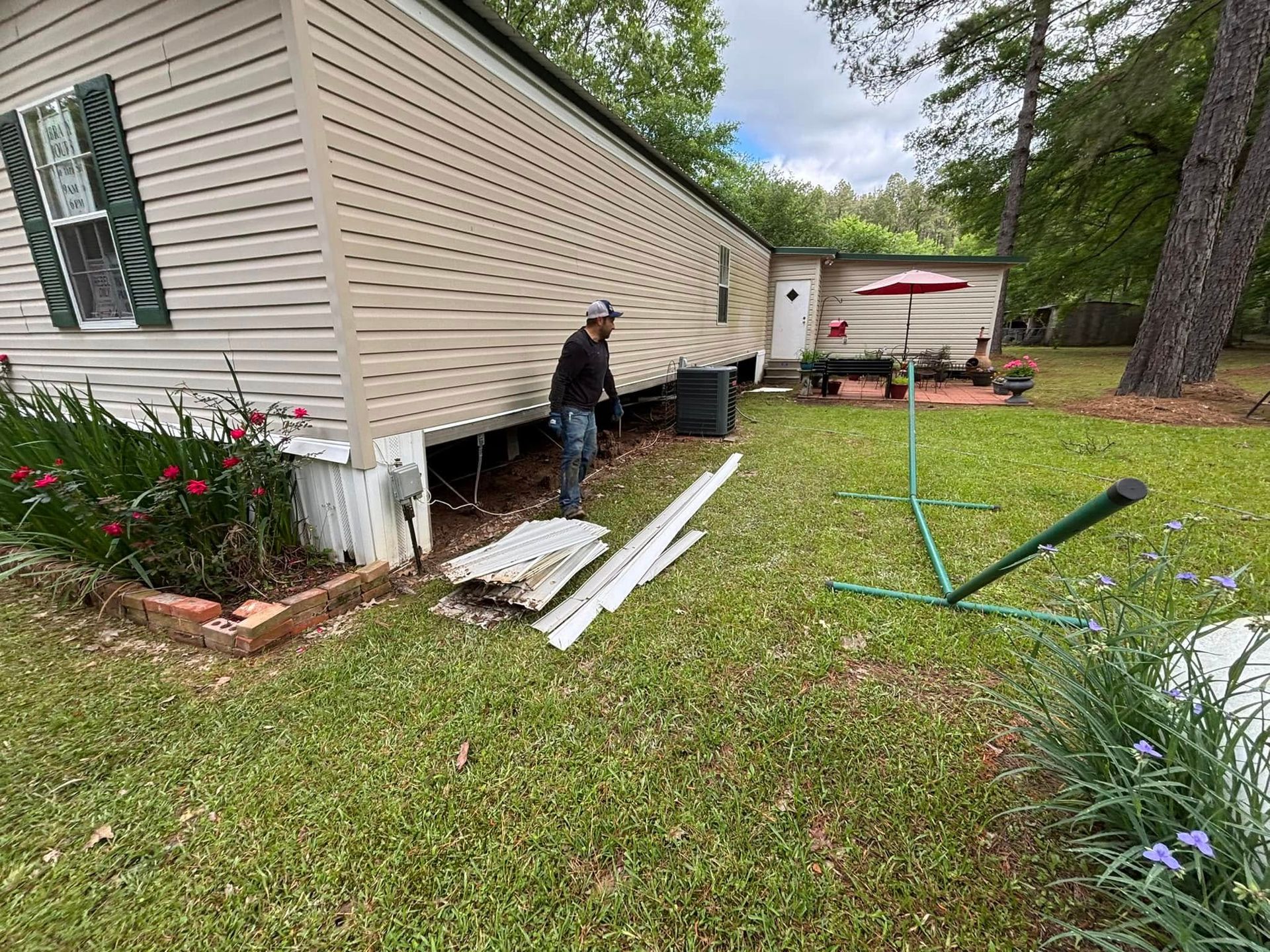 A man is standing in front of a mobile home.