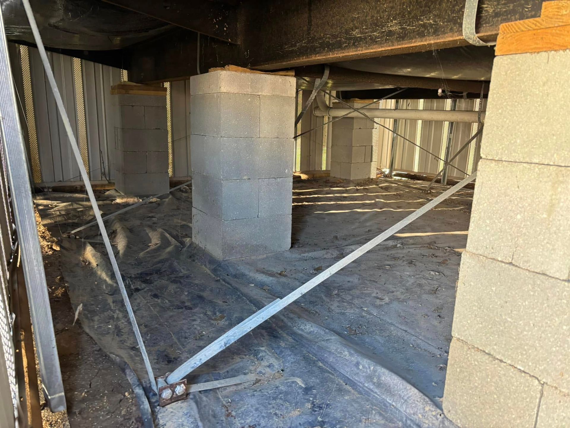 A building under construction with a lot of bricks and concrete pillars.