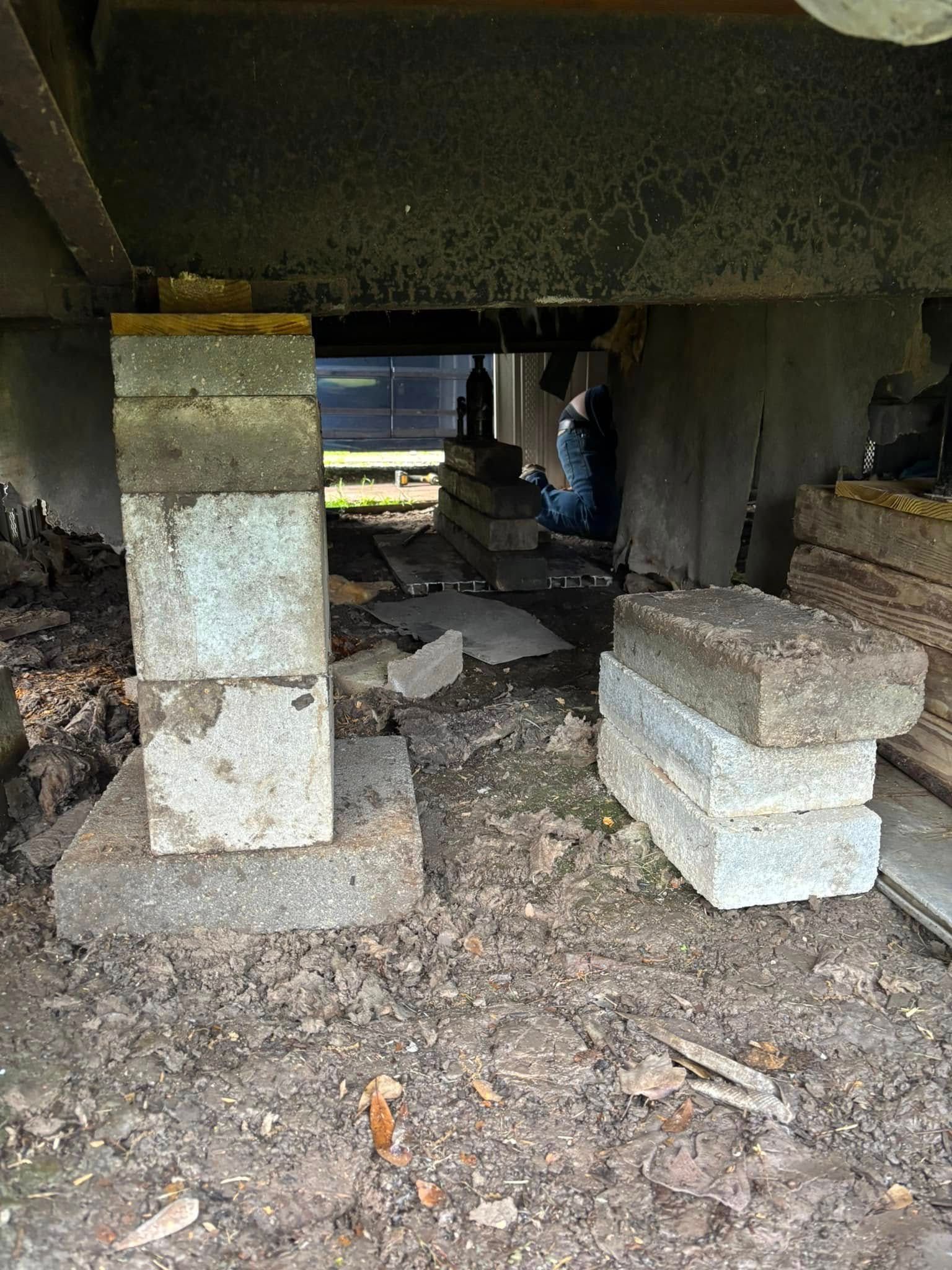 A pile of concrete blocks sitting under a bridge.