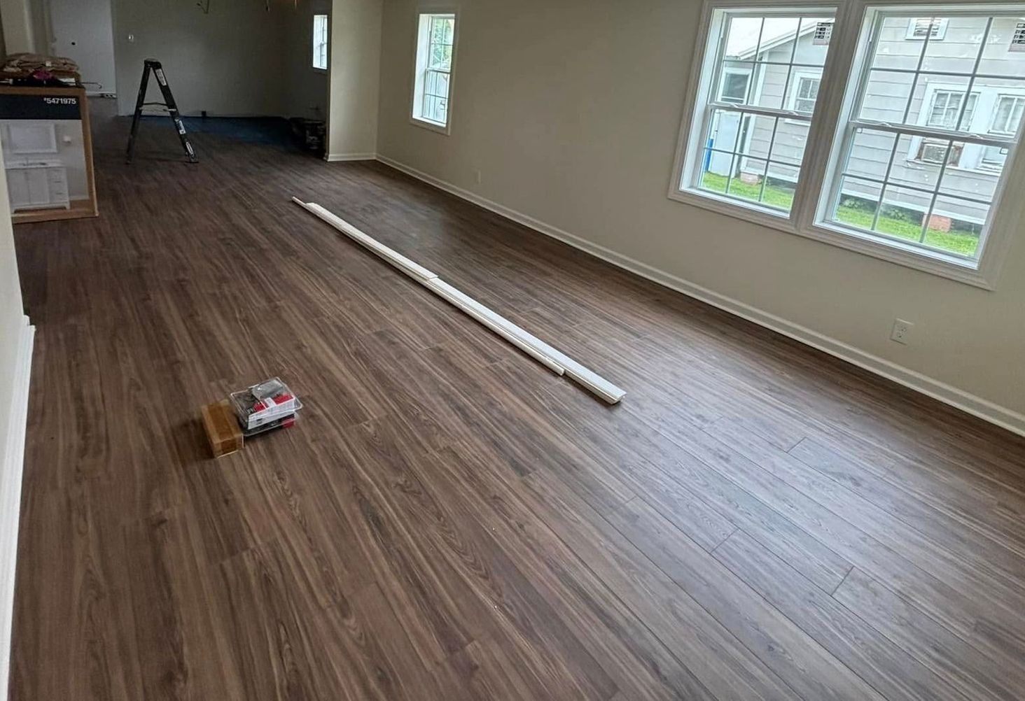 A large house with a lot of windows and a garage on a rainy day.