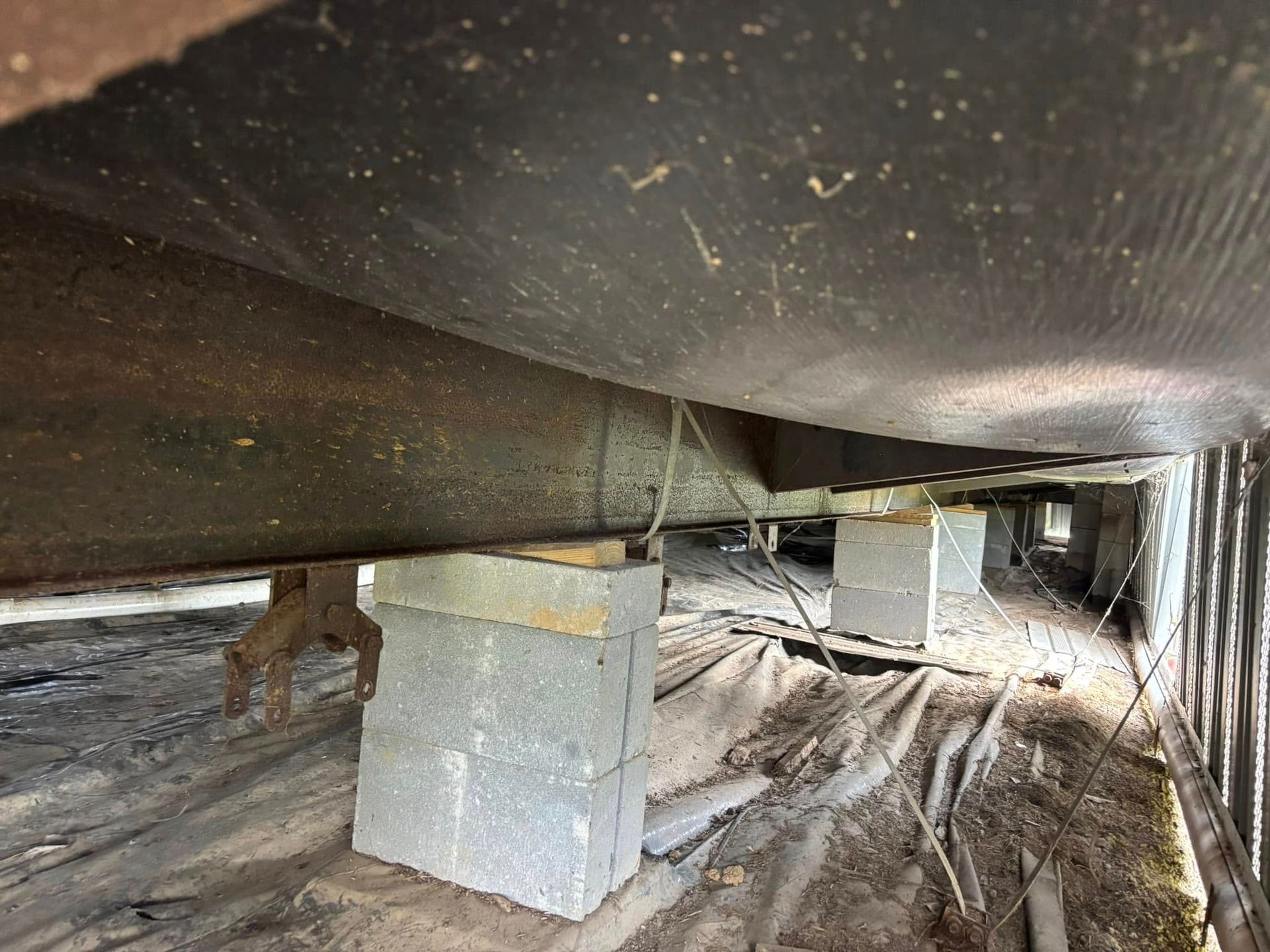 A large pipe is sitting on top of concrete blocks.