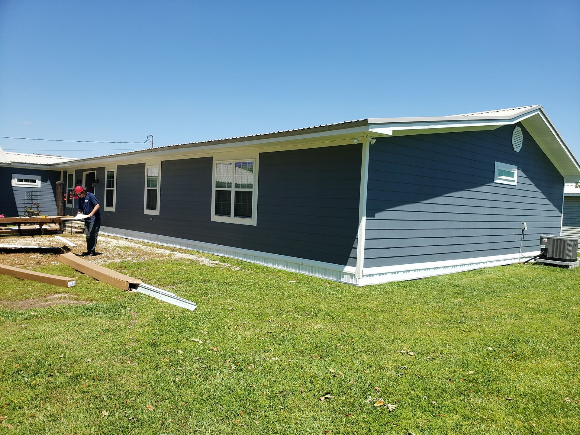 A man is standing in front of a mobile home.