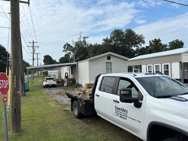 Gray cinder block foundation supporting a structure with metal supports; outdoor setting.