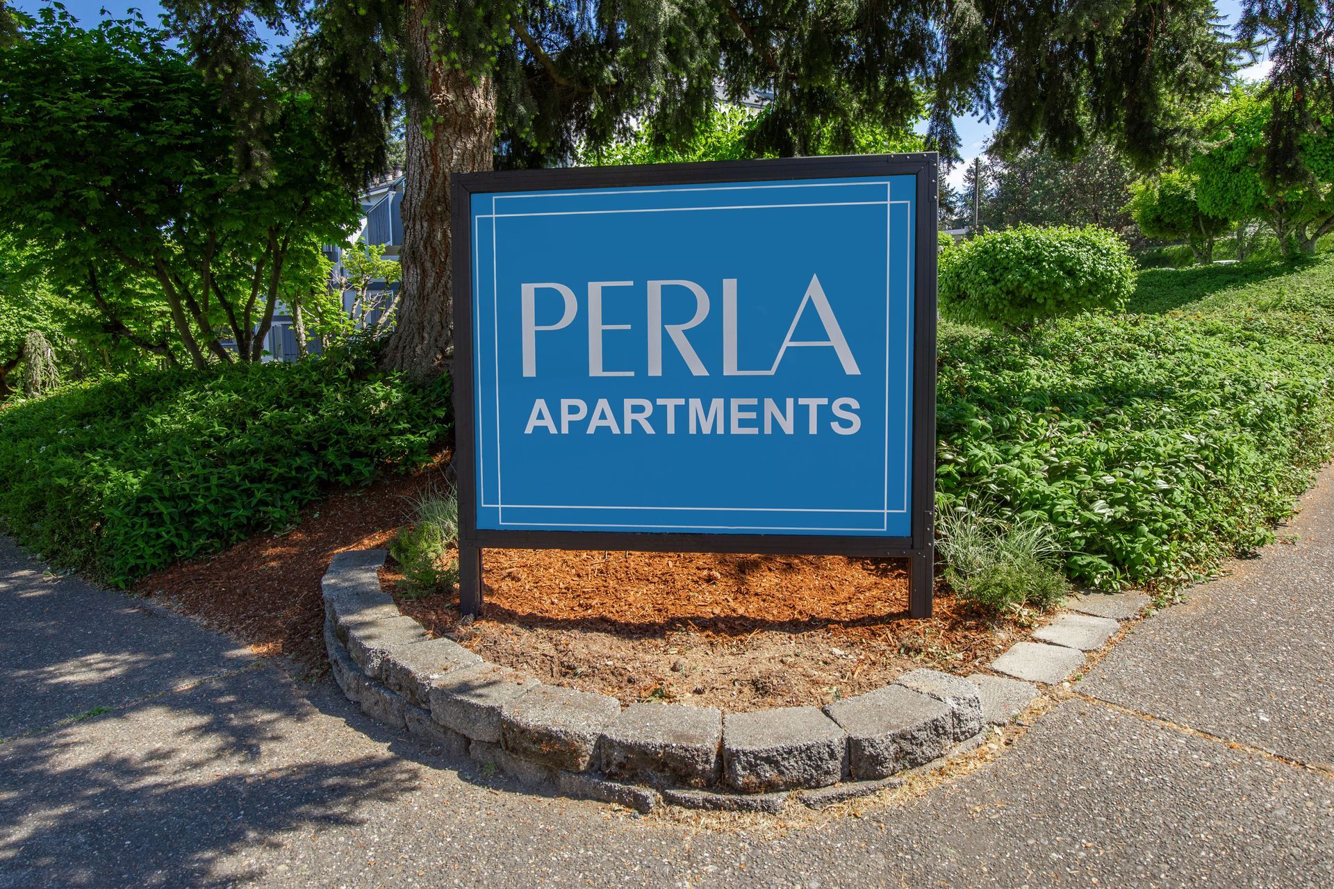 A blue sign that says perla apartments on it