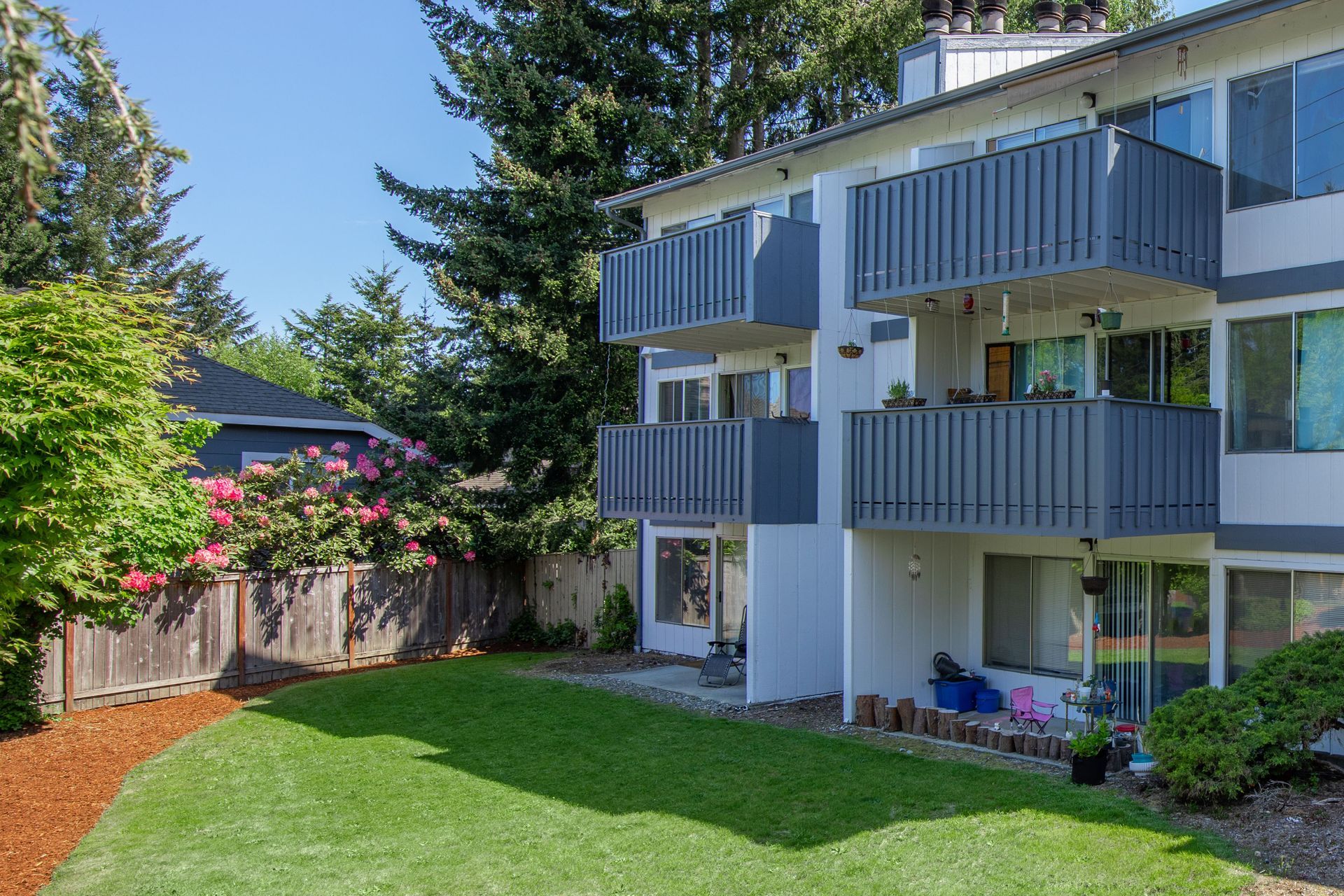 A large apartment building with a large lawn in front of it