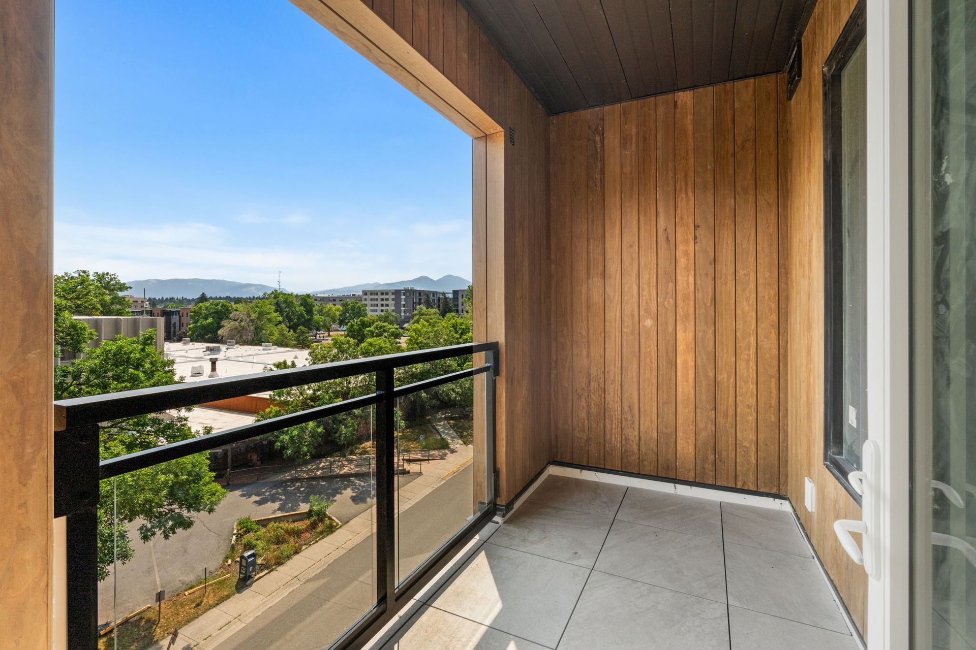 Balcony view from The Ives Bozeman apartment overlooking downtown and nearby mountain scenery