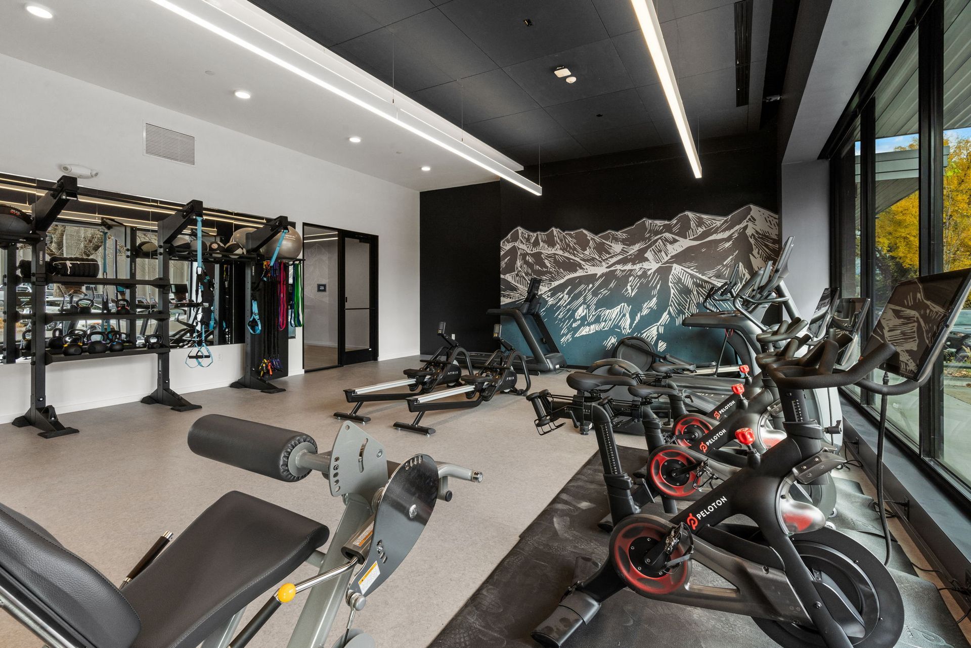 Fitness center at The Ives Bozeman with modern gym equipment and bright lighting.