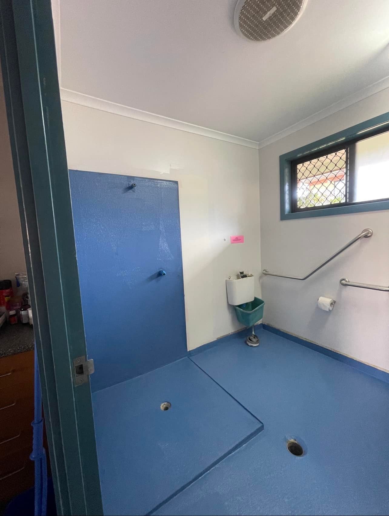 A Bathroom with a Blue Floor, a Sink, and a Shower — Waterproofing Solutions in Toowoomba, QLD