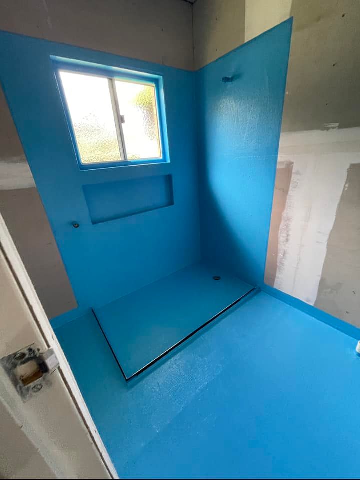 A Blue Bathroom With a Window and A Blue Floor — Waterproofing Solutions in Toowoomba, QLD