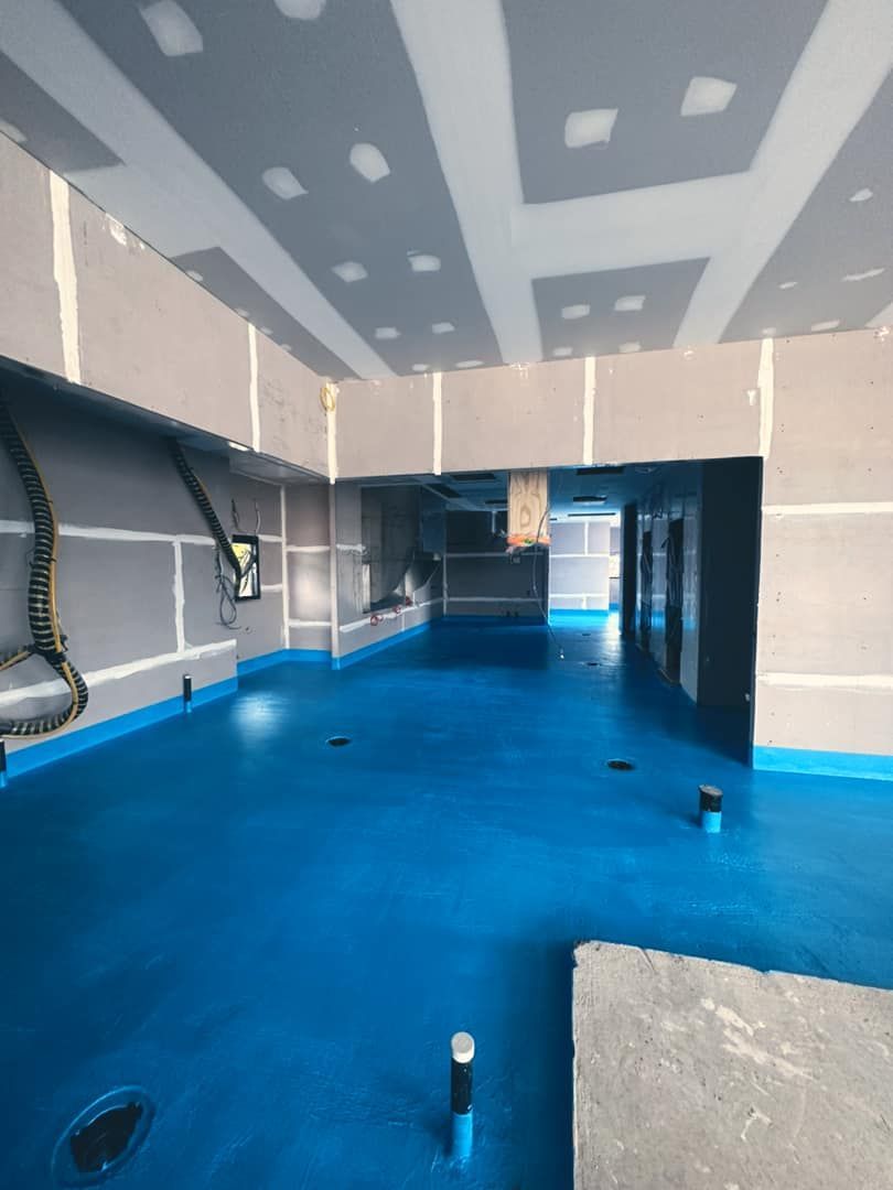 A Room with a Blue Floor and a White Ceiling — Waterproofing Solutions in Toowoomba, QLD