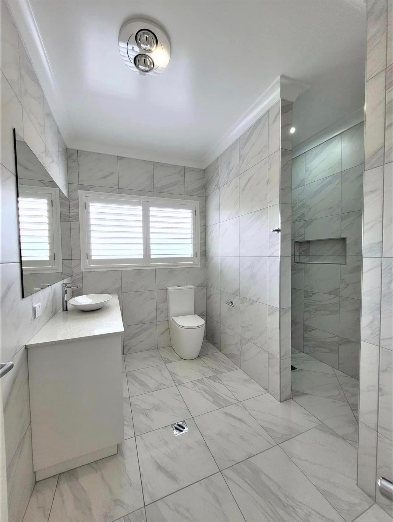 Brand New Bathroom with a Toilet, Sink, Mirror, and Shower — Waterproofing Solutions in Toowoomba, QLD