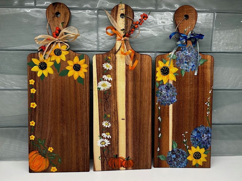 Four wine glasses with red wine and chocolate candies on a glass table.