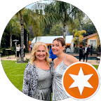 Two women are posing for a picture in a circle with a star in the middle.