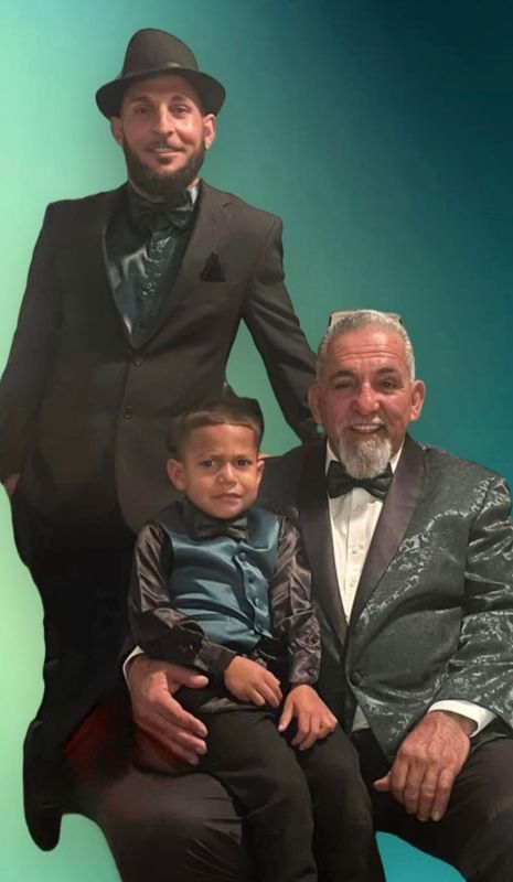 Three men in suits and bow ties are posing for a picture.