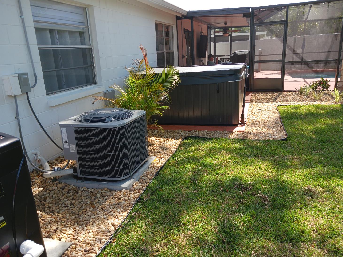 There is a hot tub in the backyard of a house.