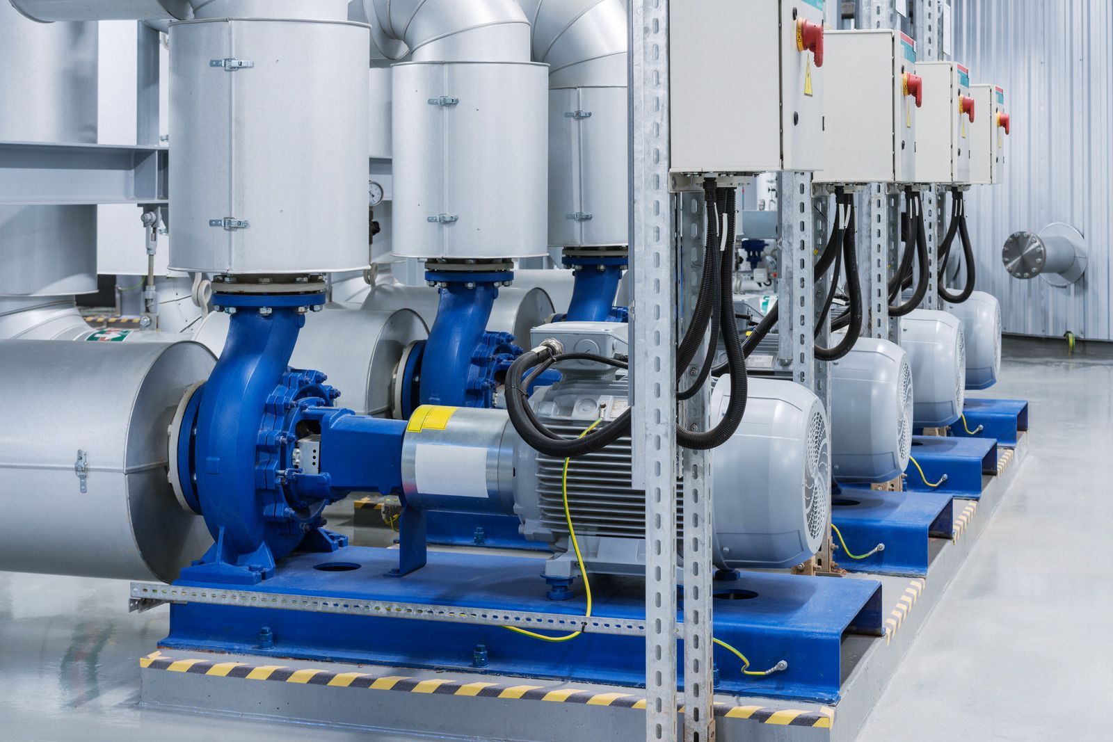 A row of water pumps are lined up in a factory.