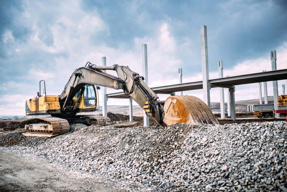 Large Excavator is Digging a Pile of Gravel at a Construction Site — On Demand Diggers & Demolitions in Molendinar, QLD