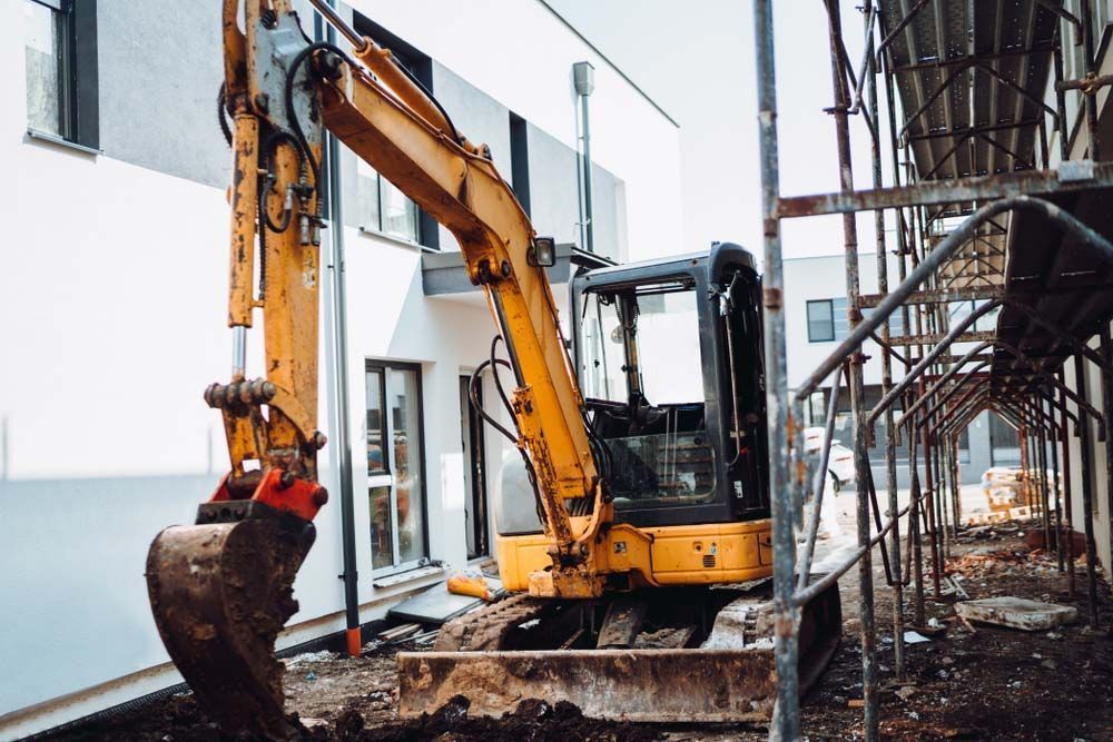 Yellow Excavator is Digging a Hole in a Building Under Construction — On Demand Diggers & Demolitions in Regional, QLD