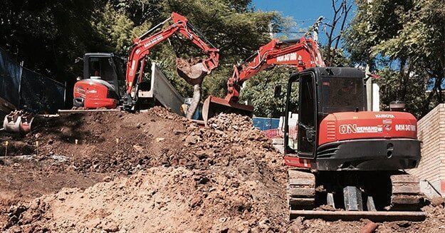 Couple of Excavators Are Sitting on Top of a Pile of Dirt — On Demand Diggers & Demolitions in Gold Coast, QLD