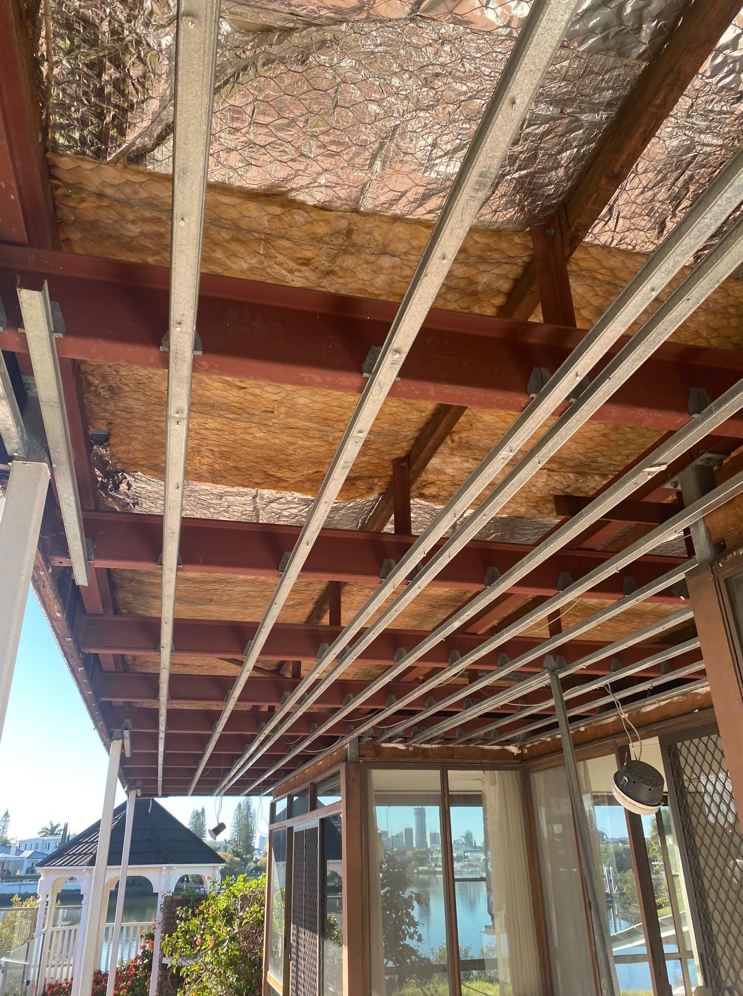 Brown Wooden Beams and Metal Tracks with Insulation — On Demand Diggers and Demolitions in Byron Bay, NSW