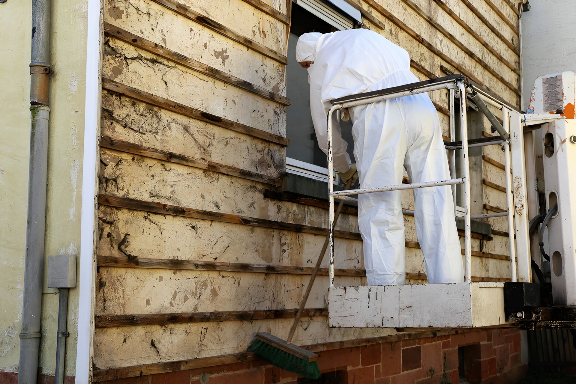 Two Men in Protective Suits Are Removing Asbestos From the Roof — On Demand Diggers & Demolitions in Molendinar, QLD