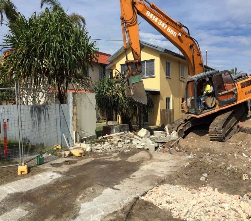 Large Excavator is Demolishing a Yellow House — On Demand Diggers & Demolitions in Molendinar, QLD