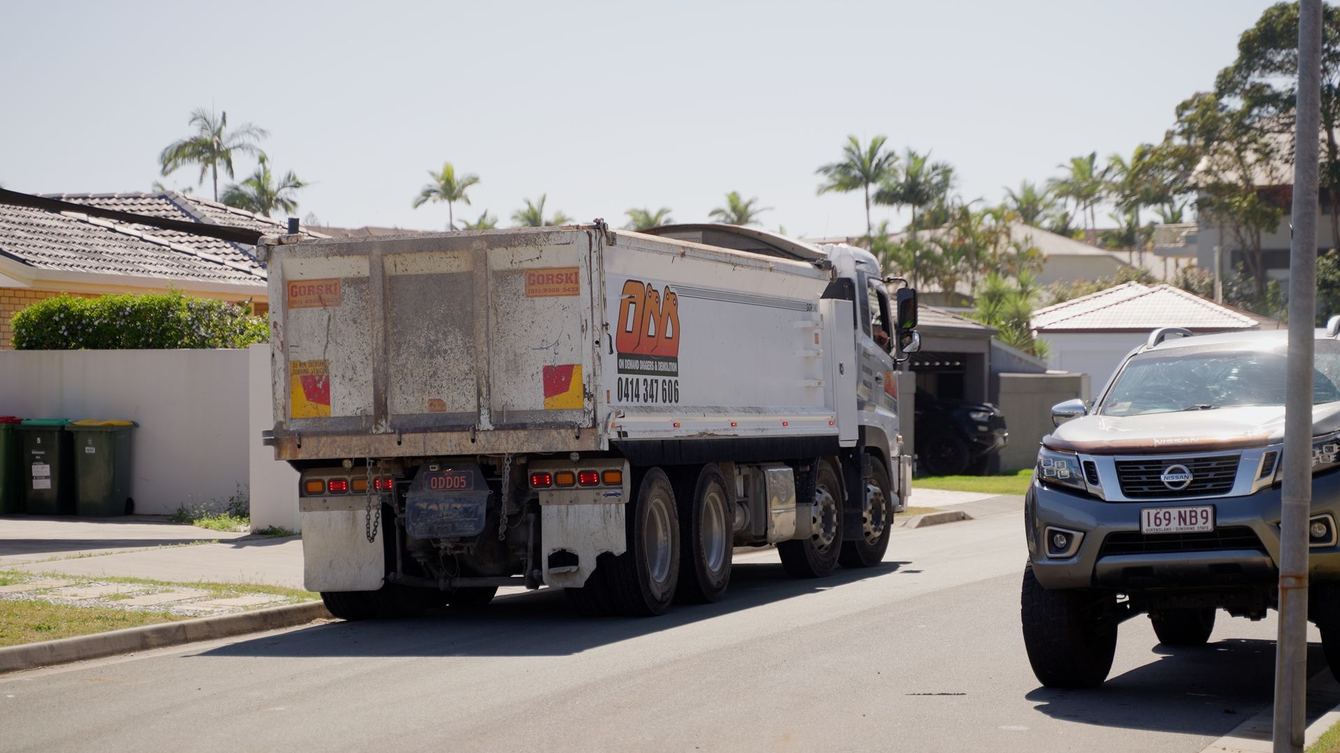 Large Excavator Bucket is Sitting on Top of a Pile of Rocks — On Demand Diggers & Demolitions in Sunshine Coast, QLD