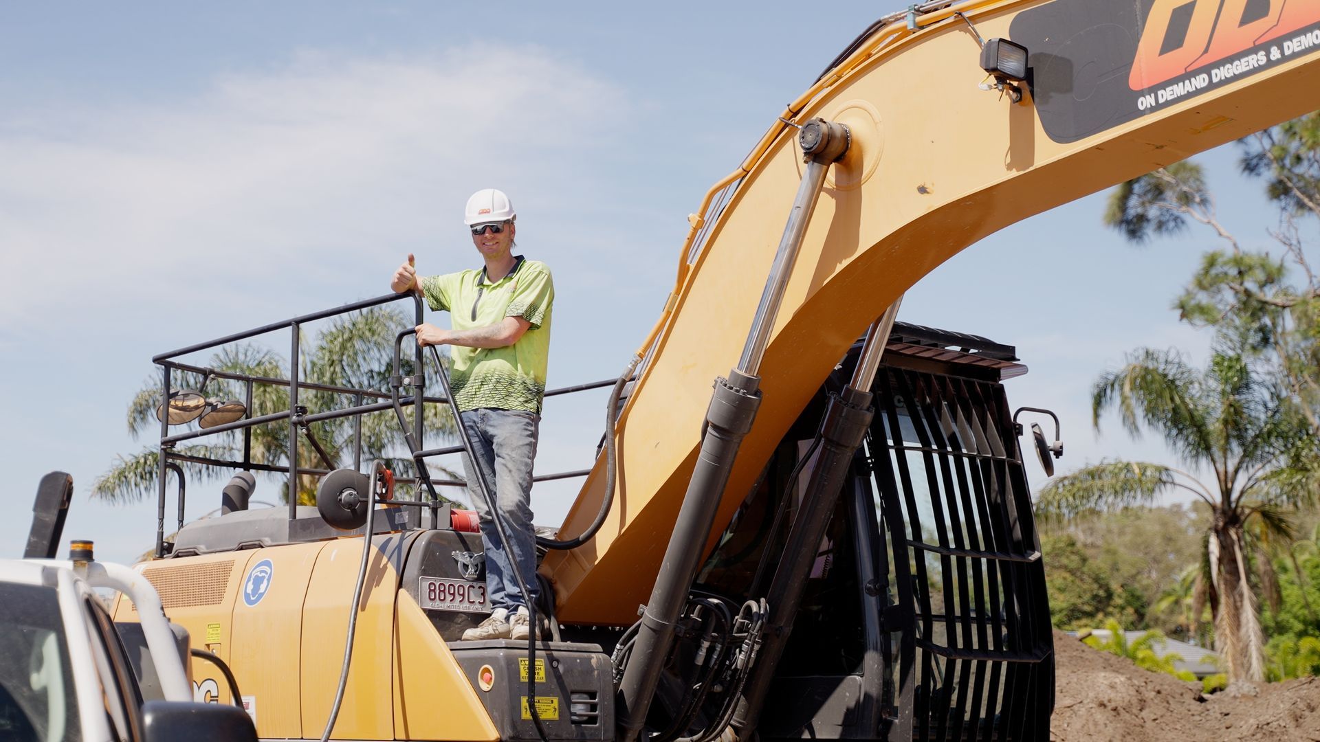 Large Orange Excavator is Digging a Hole in a Construction Site — On Demand Diggers & Demolitions in Molendinar, QLD