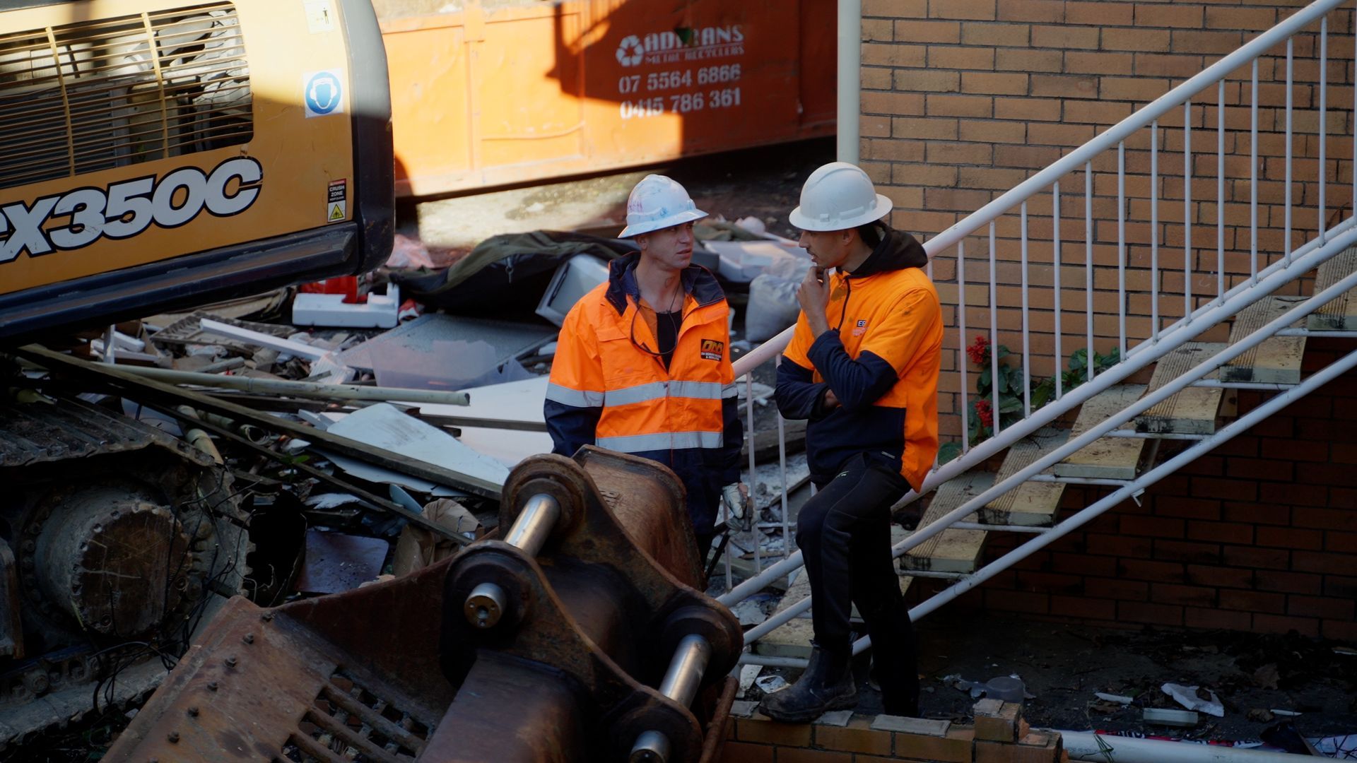 Group of People in Protective Suits Are Working on a Roof — On Demand Diggers & Demolitions in Molendinar, QLD