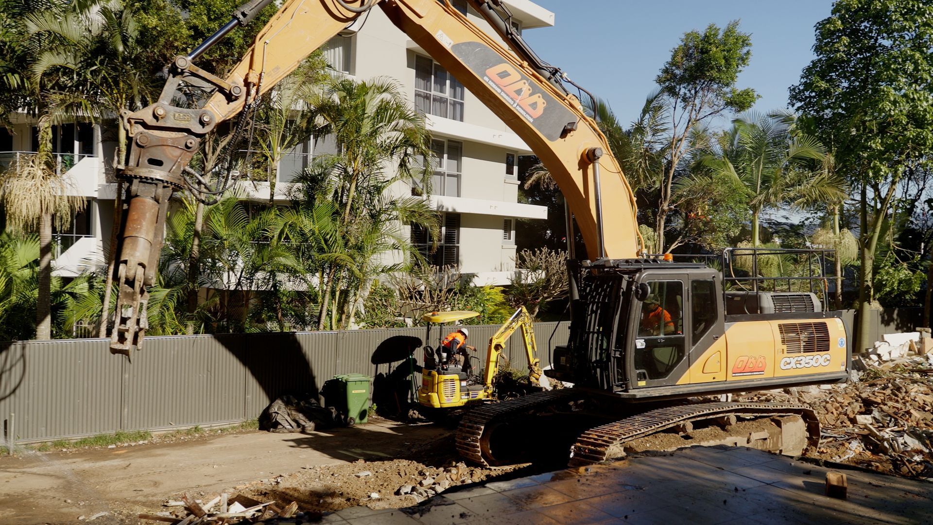 Yellow Excavator is Digging a Hole in a Building Under Construction — On Demand Diggers & Demolitions in Regional, QLD
