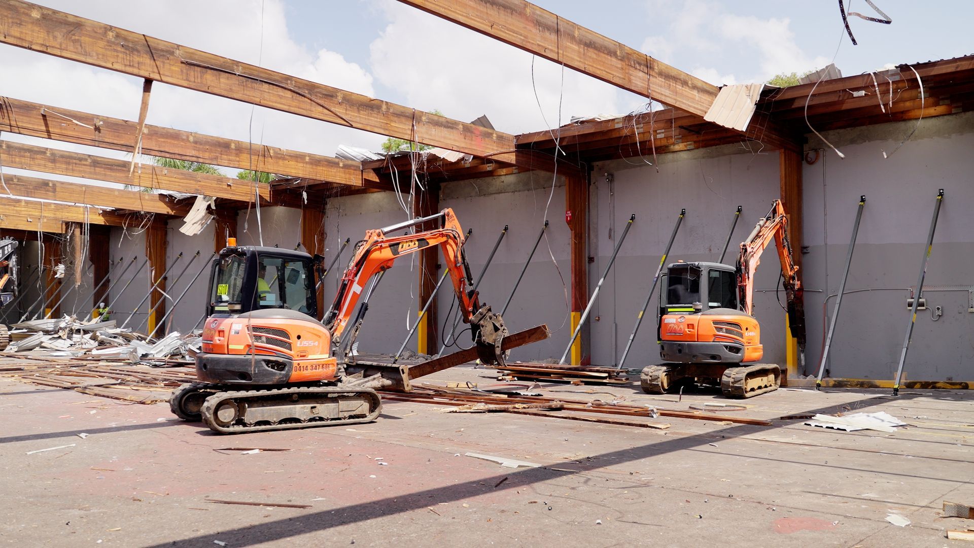 Large Yellow Excavator is Demolishing a Building on a Construction Site — On Demand Diggers & Demolitions in Molendinar, QLD