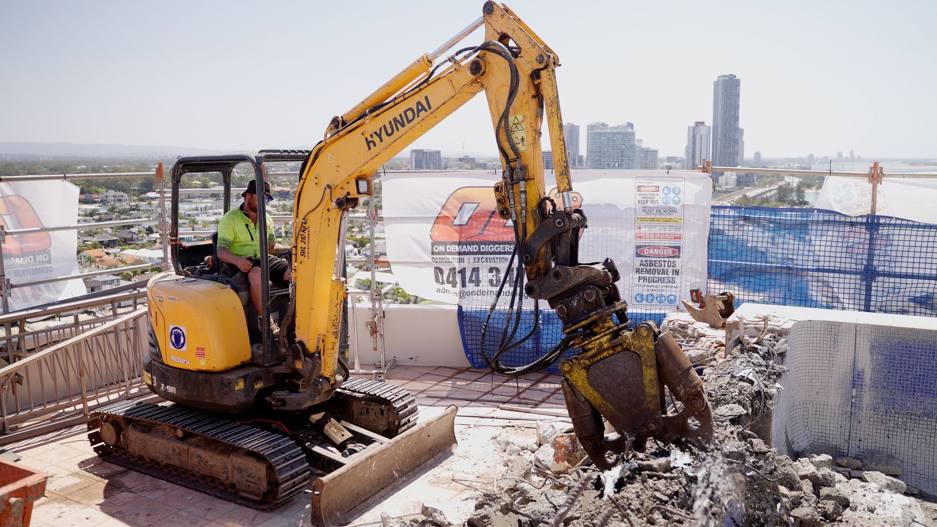 Yellow Excavator is Demolishing a Building in the Snow — On Demand Diggers & Demolitions in Molendinar, QLD