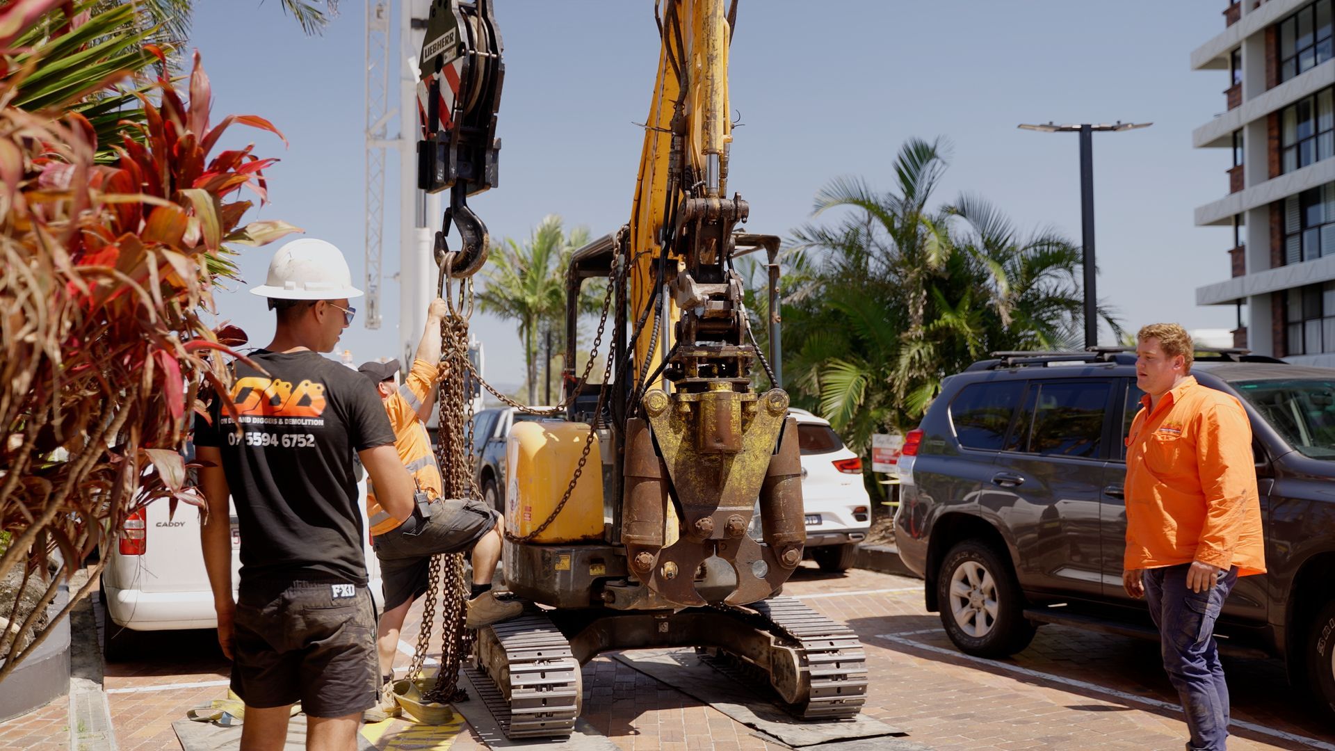 Small Orange Bulldozer is Driving Through a Muddy Field in the Woods — On Demand Diggers & Demolitions in Molendinar, QLD