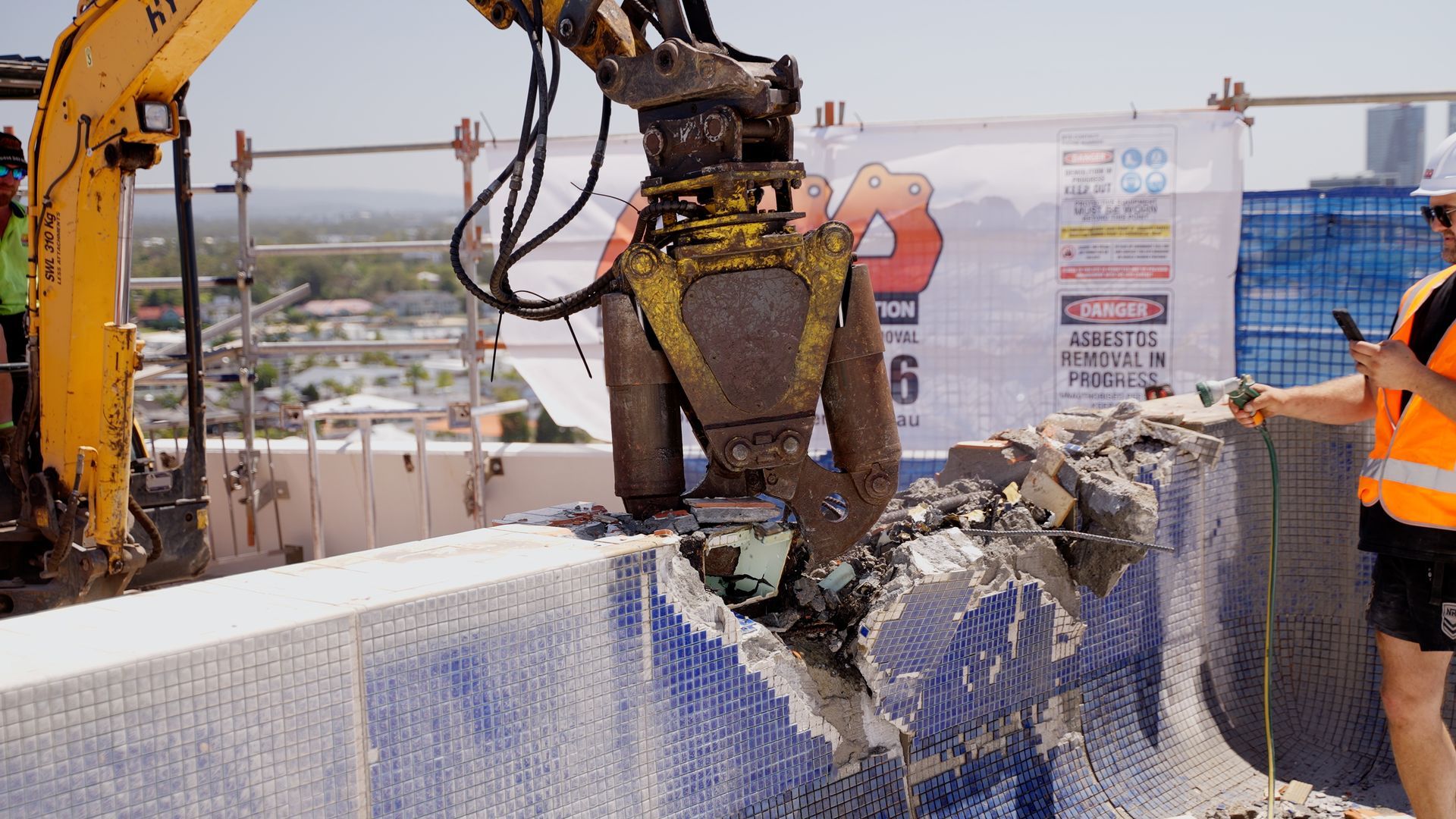 A Man is Working on a Boat in a Garage — On Demand Diggers & Demolitions in Molendinar, QLD