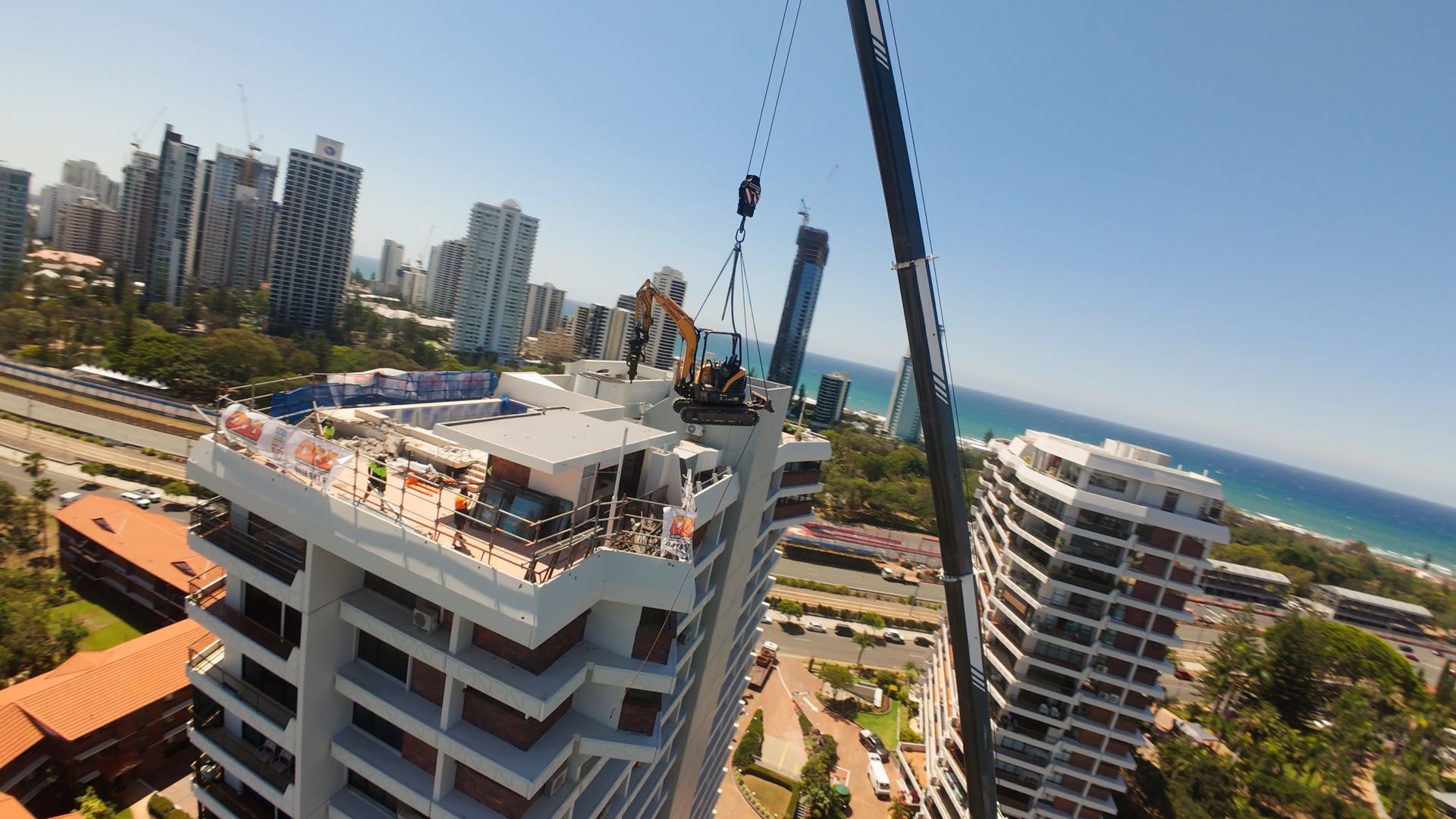 Large Bucket is Sitting in Front of a Building That is Being Demolished — On Demand Diggers & Demolitions in Gold Coast, QLD