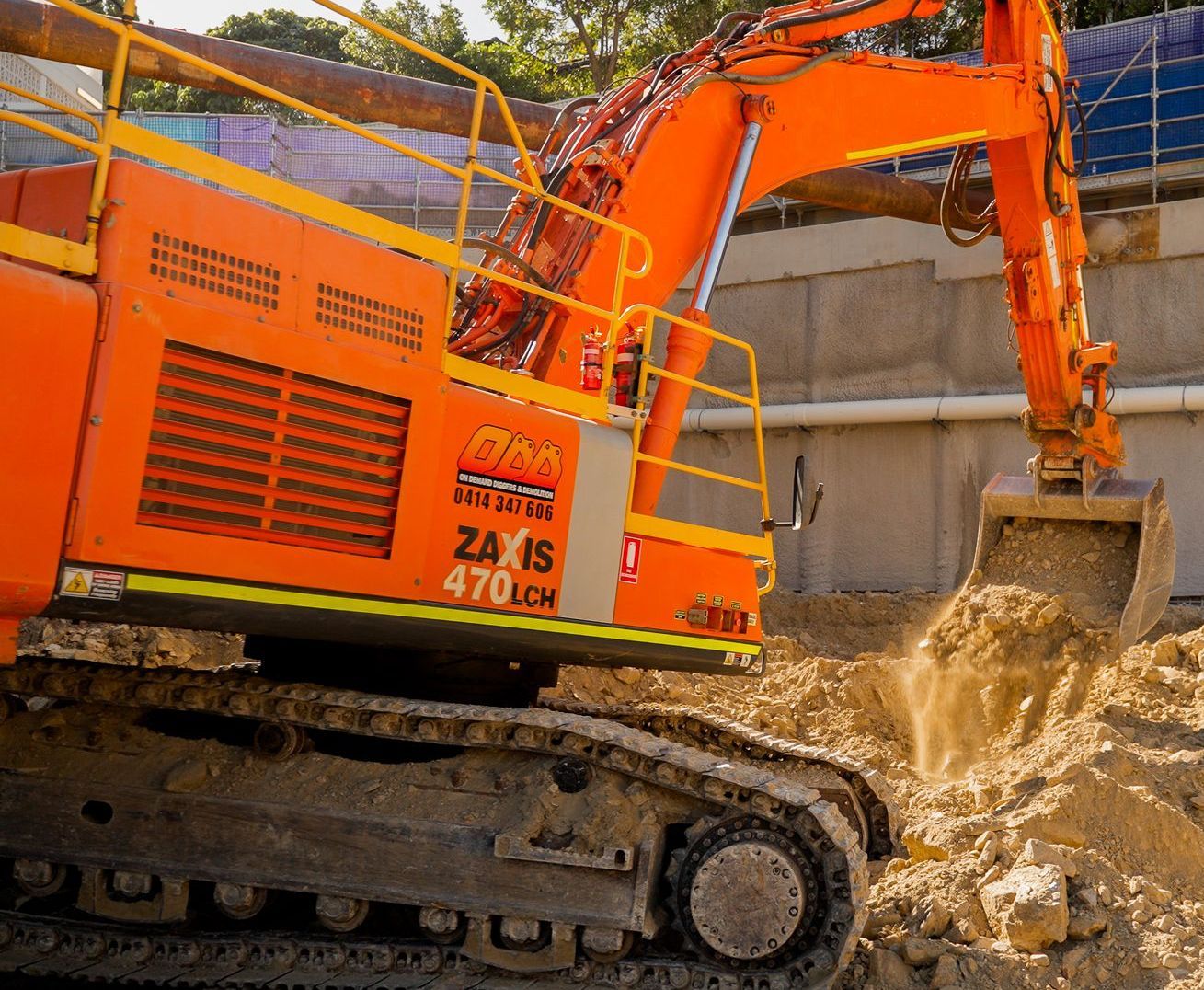 Orange Excavator Digging Dirt at a Construction Site — On Demand Diggers and Demolitions in Molendinar, QLD