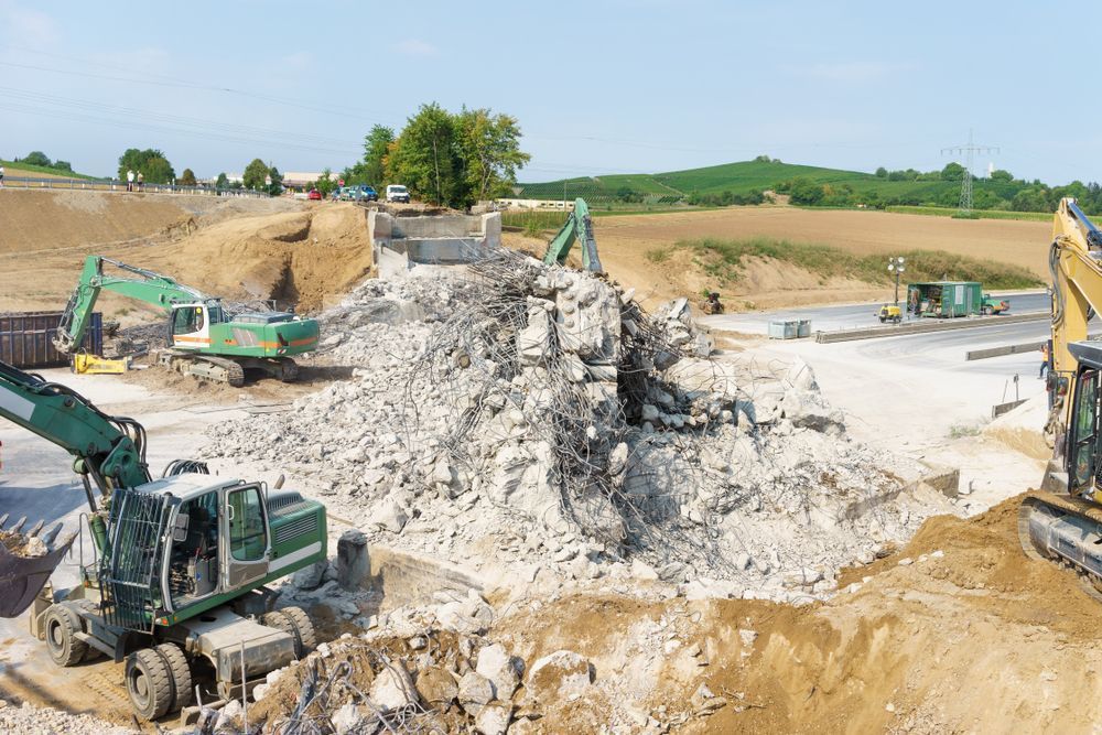Construction Site With Excavators Demolishing A Concrete Structure — On Demand Diggers & Demolitions in Molendinar, QLD