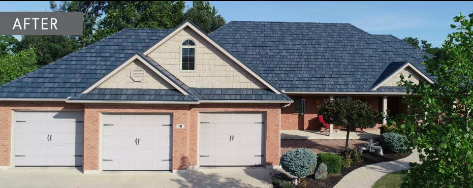A house with a blue roof, three garage doors, and brick siding;